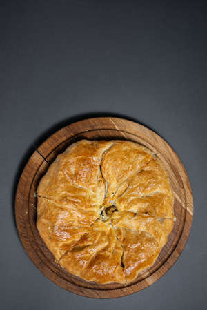 georgian khachapuri with mushrooms and potato or cheese pie on wooden boardの写真素材