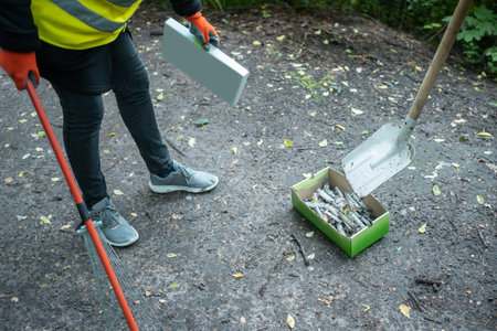 volunteer cleaning up park from used syringe by drug addicted junkies