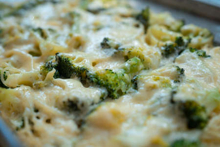 fresh delicious baked broccoli with melted cheese and spaghettiの写真素材