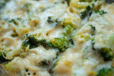 fresh delicious baked broccoli with melted cheese and spaghettiの写真素材