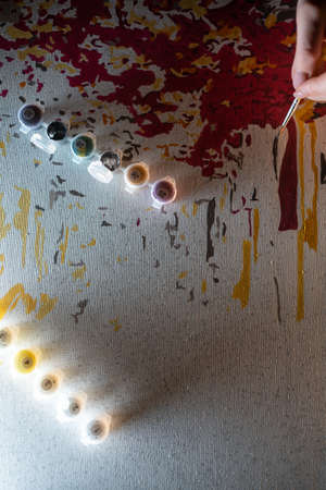 person hand drawing picture with painting by numbers with brush, acrylic, macroの写真素材