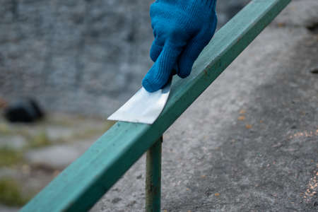 volunteer worker painting and renovate railing or fence in public parkの写真素材