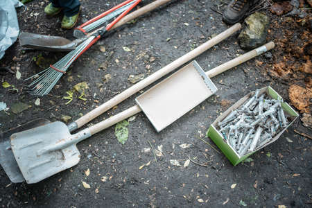 volunteer cleaning up park from used syringe by drug addicted junkiesの写真素材