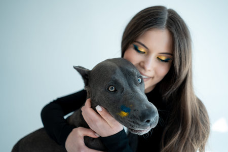 young ukrainian beautiful female play with staffordshire terrier dog at hoe