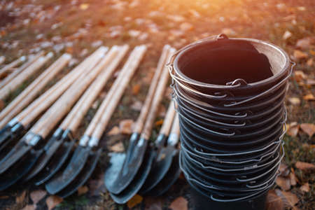 closeup of plastic bucket and shovel on grass or gardening tools for plantingの写真素材