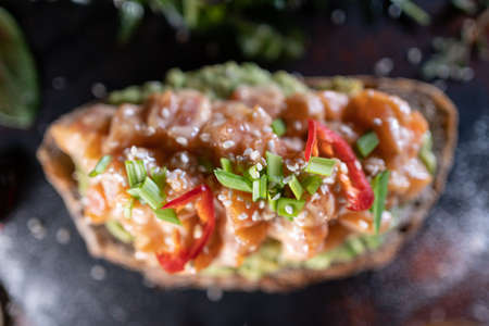 fresh sandwich with avocado, red salmon fish, arugula, tomato, salad, greenの写真素材