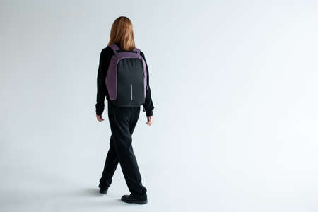 stylish hipster person holding modern backpack bag on white backgroundの写真素材