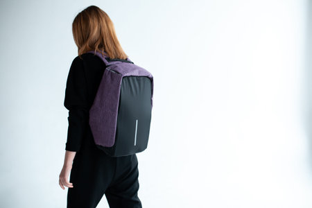stylish hipster person holding modern backpack bag on white background