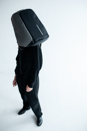 stylish hipster person holding modern backpack bag on white background