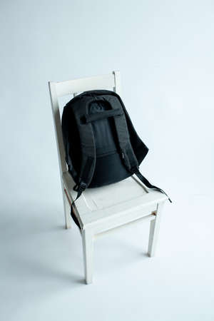modern stylish backpack on chair studio shotの写真素材