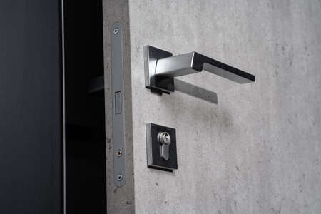 modern and secured metal door handle and latch detailの写真素材