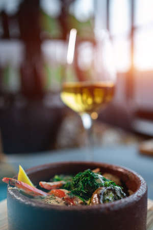 stewed mushroom with cream sauce or dill in bowl and wine glass in restaurantの写真素材