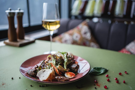 salad with chicken liver, egg and crouton or wine in glass on restaurant table