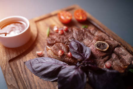 fresh lamb steak meat with berry sauce, tomato, rosemary, basil, pomegranateの写真素材