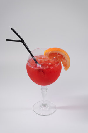 red grapefruit juicy cocktail isolated with strawの写真素材