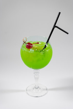 fresh green midori sour cocktail with liquor isolatedの写真素材