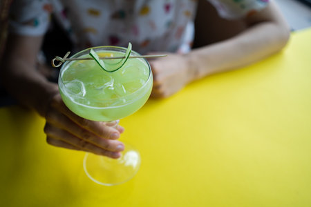 female drink green alcohol fruit cocktail with cucumber, lime, kiwi, tarragonの写真素材