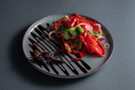 fresh georgian vegetable salad with balsamic sauce on plateの写真素材