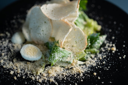 light caesar salad without meat on black plate on dark backgroundの写真素材