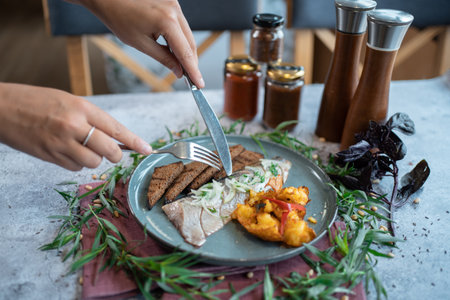 fresh marinated herring fish with potato and brown bread and onion in restaurantの写真素材