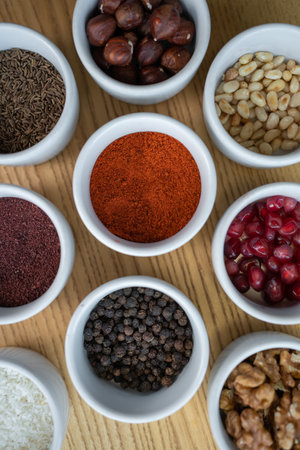 set of spices on wooden background, pomegranate, pine nut, walnut, hazelnutの写真素材