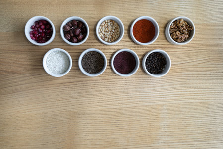 set of spices on wooden background, pomegranate, pine nut, walnut, hazelnutの写真素材