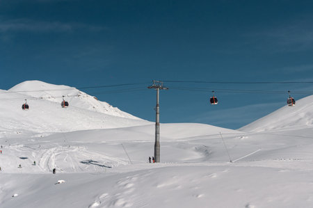 skiers and snowboarders on ski lift at winter at resortの写真素材