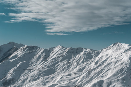 winter mountains at ski resort of caucasus Gudauri, sunny snowy dayの写真素材
