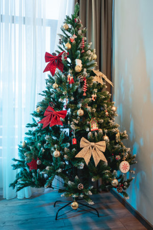 person decorating christmas tree with toys at new year eveの写真素材