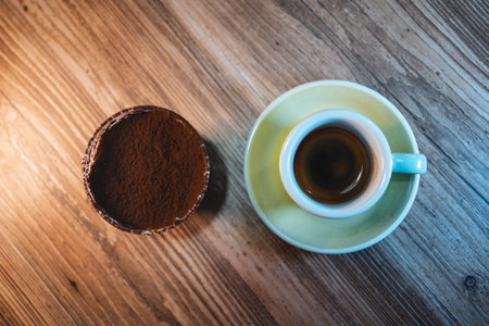 cup of espresso or americano coffee with sweet tiramisu dessert on table in cafeの写真素材