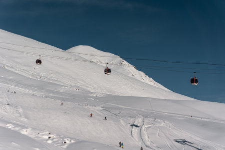 skiers and snowboarders on ski lift at winter at resortの写真素材