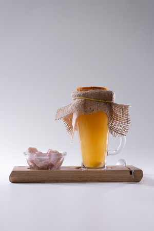fresh orange vitamin ginger and sea buckthorn tea cup and pink sugar isolatedの写真素材