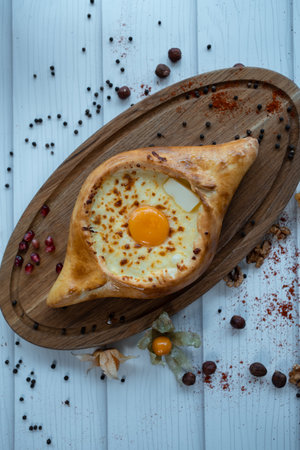 fresh adjarian khachapuri boat woth suluguni cheese, egg yolk and butterの写真素材