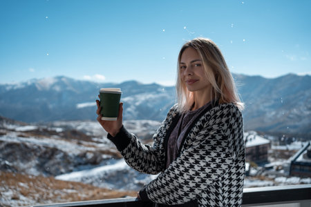 female drink hot coffee drink from disposable cup at nature, mountainsの写真素材