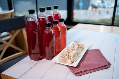set of georgian khinkali with homemade red wine or chacha in plastic bottlesの写真素材