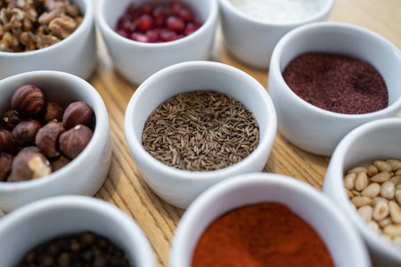 set of spices on wooden background, caraway cumin, hazelnut, pine nutの写真素材