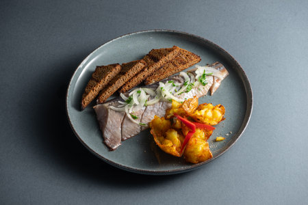 fresh marinated herring fish with potato and brown bread and onion isolatedの写真素材