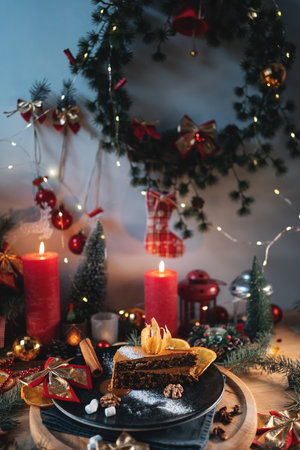chocolate pie or cake with nut or hazelnut and brown cream at christmas decorの写真素材