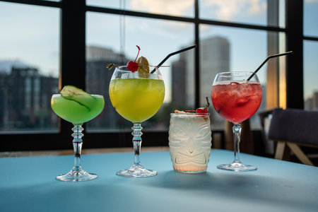 set of color alcohol stylish cocktails in bar or restaurant, green, red, yellowの写真素材