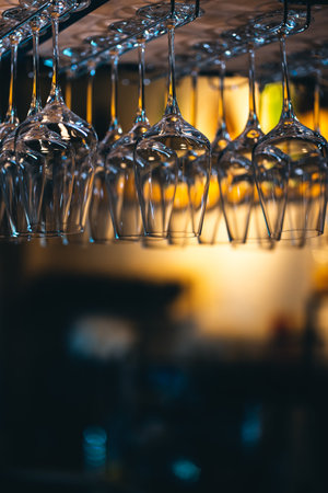 set of shiny dry wineglasses over bar counter in nightclubの写真素材