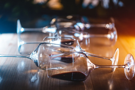 set of glasses with luxury red and white wine lying on wooden table conceptの写真素材