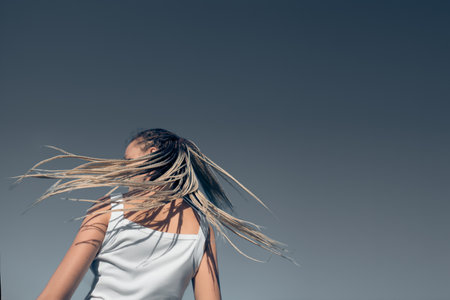 Beautiful woman waving hair with stylish afro braidsの写真素材