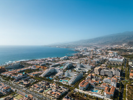 ocean shore with hotels and beach, Los Cristianos, Tenerife, Canary, aerial shotの写真素材