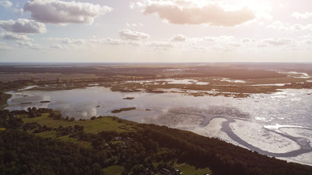 aerial view of Khrinnyky water reservoir, lake or swamp, with field and forest