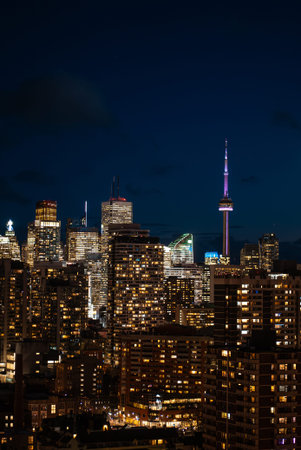 night Toronto city downtown skyline, twilight over CN Tower and skyscrapers of financial district...