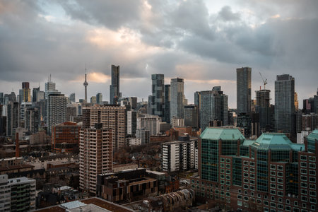 Toronto city downtown skyline, clouds over CN Tower and skyscrapers of financial district Canada