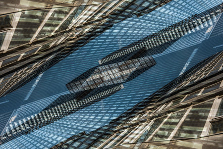 symmetry and mirrored geometry pattern, reflected skyscrapers and modern buildings abstract background, lines and tunnel futuristic technology conceptの写真素材