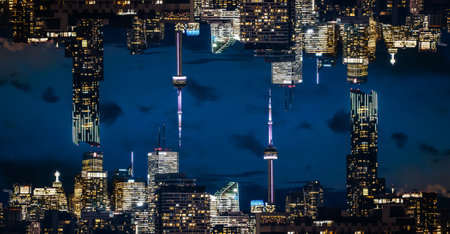 symmetry and mirrored geometry pattern, reflected skyscrapers of Toronto and modern buildings skyline abstract background, lines and tunnel futuristic technology conceptの写真素材