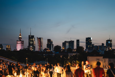 sunset over skyline of Warsaw city with skyscrapers and downtown district, crowd of people walking, tourist travel destination, rush hour in capital of Poland 4k, vertical video footageの写真素材