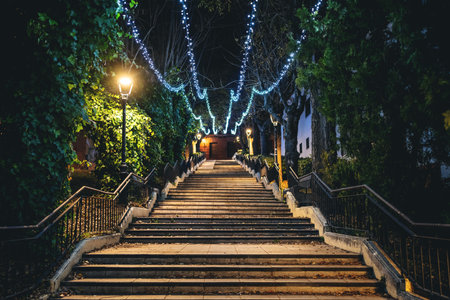 mysterious stairs with glowing illumination in beautiful night park, atmospheric mood and tranquil vibes, charming dusk alleyの写真素材